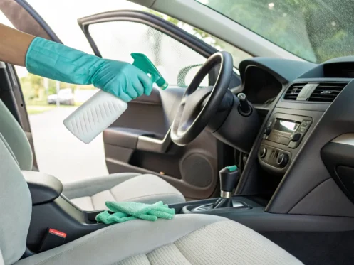 How to remove mold from a car interior by spraying a seat with cleaner.